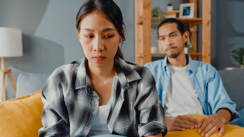 tense couple sitting on couch