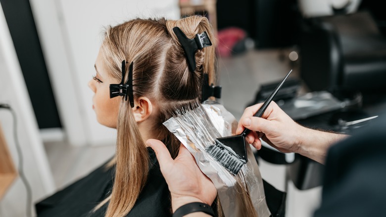 A woman getting her hair colored 