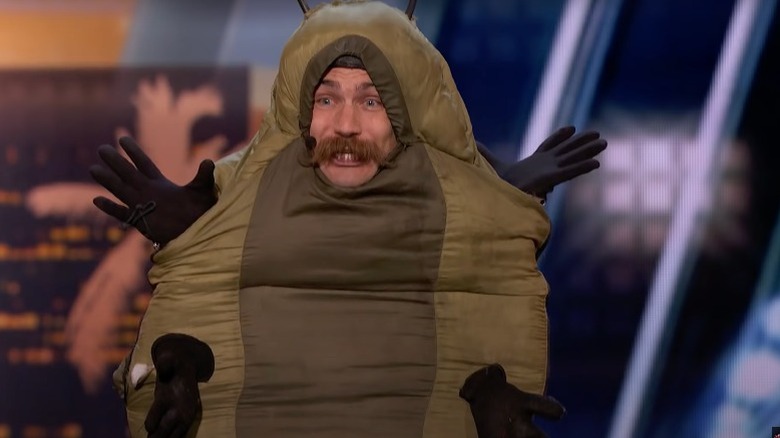 Man dressed like a caterpillar performs