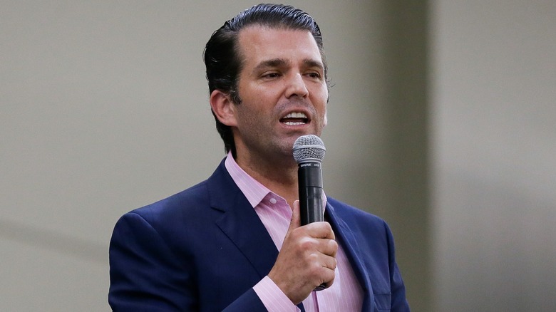 Donald Trump Jr. speaking into a microphone on stage