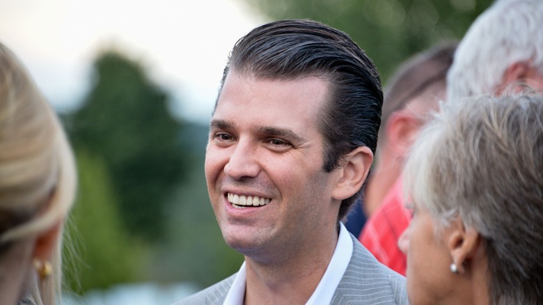 Donald Trump Jr. speaks in 2016 in front of a sign for his father's campaign