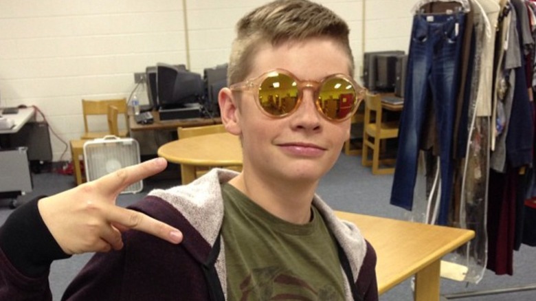 Jacob Lofland as a kid making a peace sign