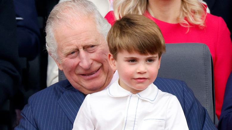 Prince Louis sitting on a smiling King Charles III's lap at the 2022 Platinum Jubilee