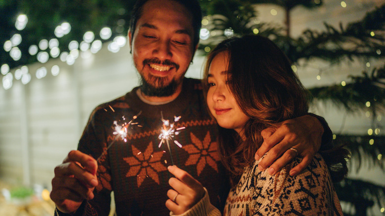 Couple holding sparklers