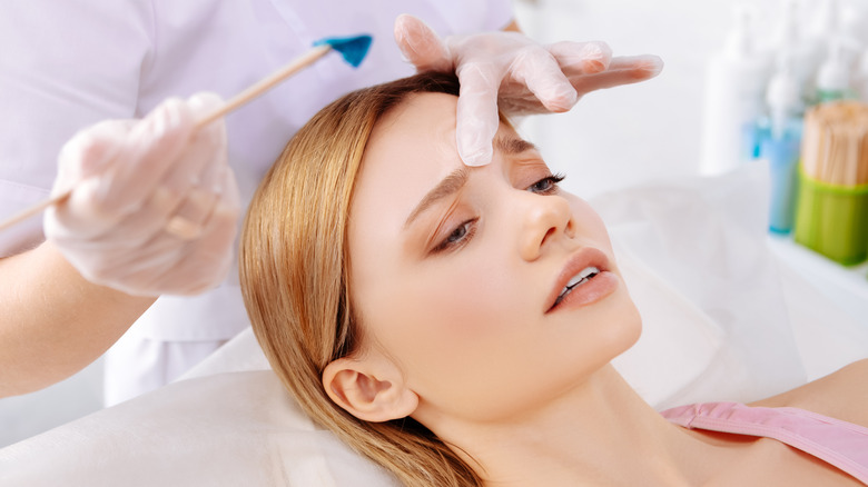 Woman getting eyebrows waxed