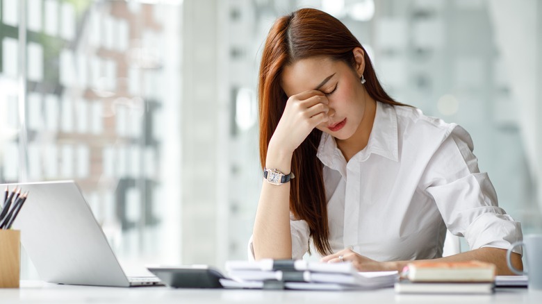 Woman at desk with headache