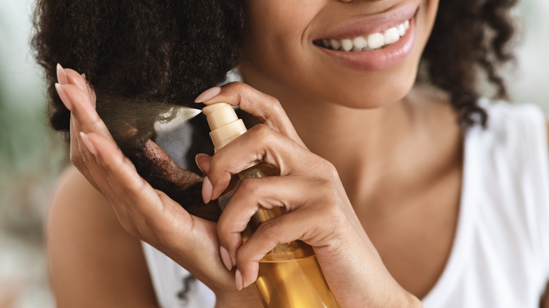 woman spraying curls with salt spray