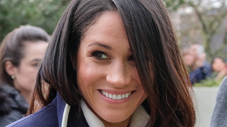 close up of a smiling Meghan Markle 