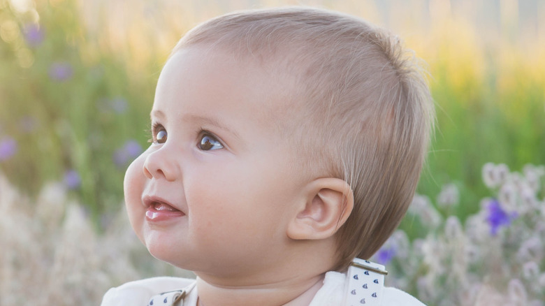 Baby sitting in field