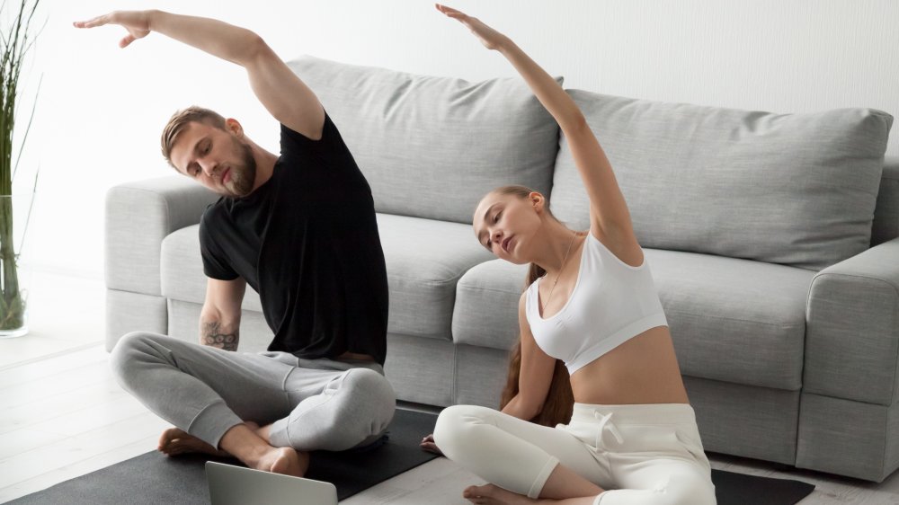 A couple doing yoga together 