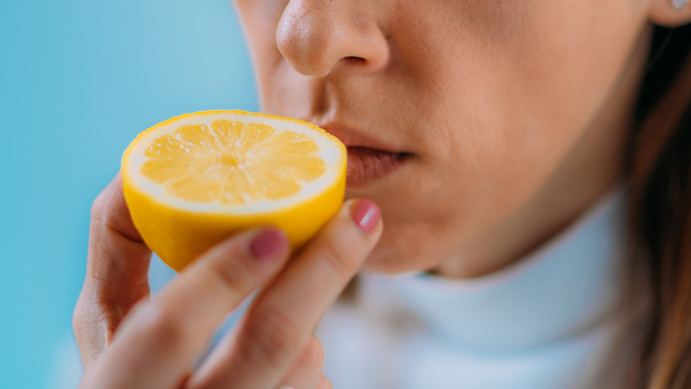 Woman smelling a lemon