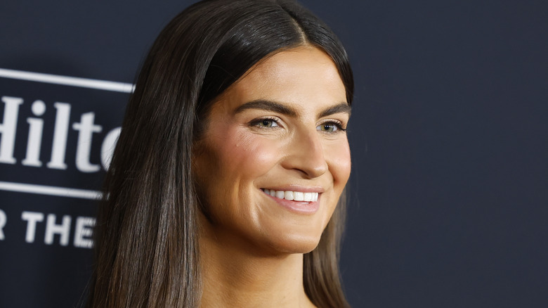 Kaitlan Collins smiling while posing at an event