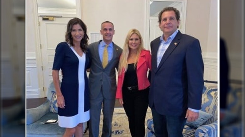 Kristi Noem and Corey Lewandowski smiling with Lee Rizzuto and Denise Rizzuto