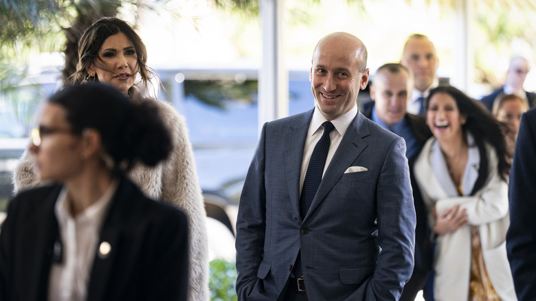 Kristi Noem and Stephen Miller walking into Mar-a-Lago together
