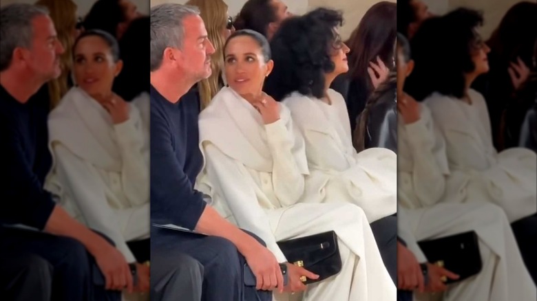 Meghan Markle sits alongside Markus Anderson at Paris Fashion Week in October 2025.