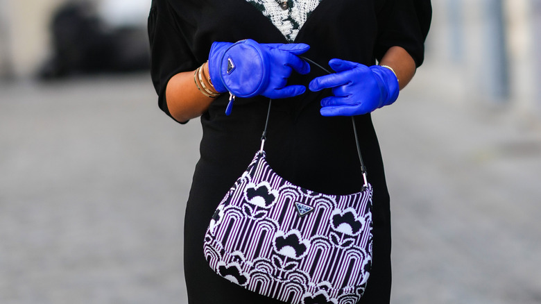 Woman wearing blue leather gloves