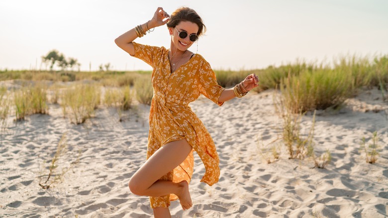 Woman smiles walking on the beach