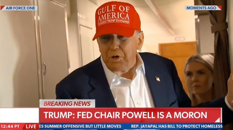 Donald Trump speaking with Karoline Leavitt behind him