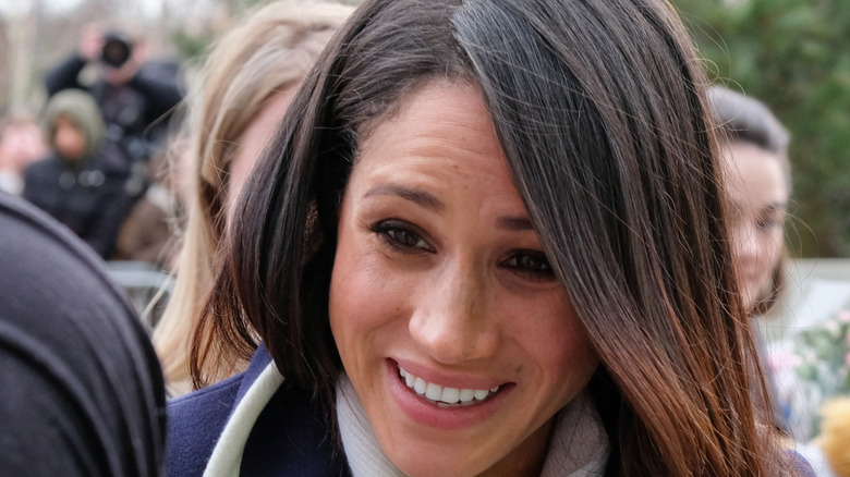 Meghan Markle outdoors crowd smiling