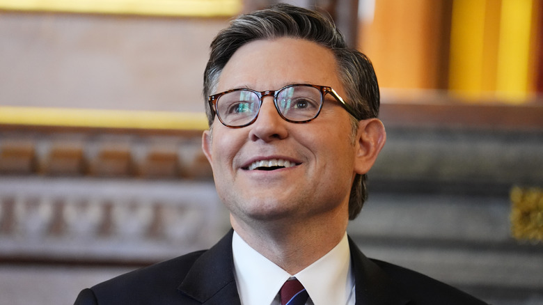 Mike Johnson weirdly smiling off into the distance