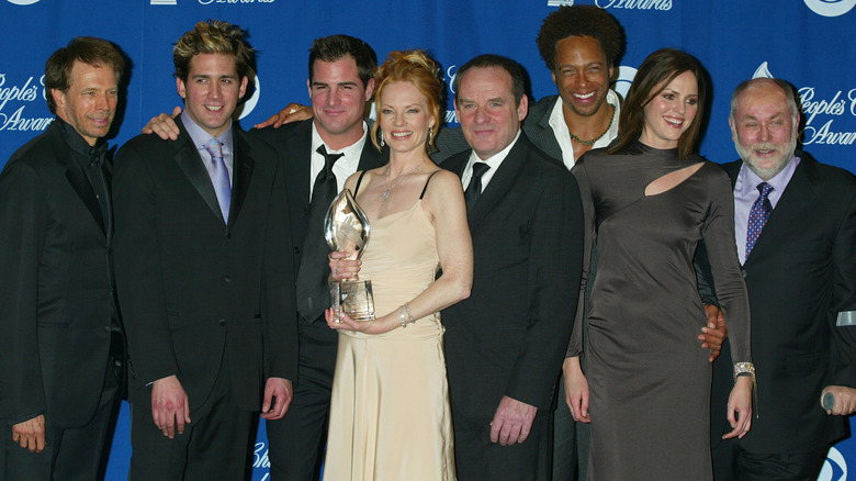 'CSI: Crime Scene Investigation' cast and crew members in formal wear posing with an award