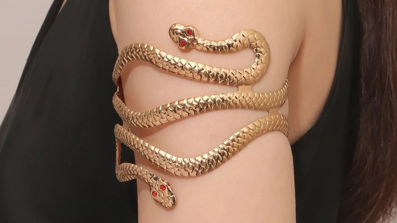 Woman wearing snake arm cuff