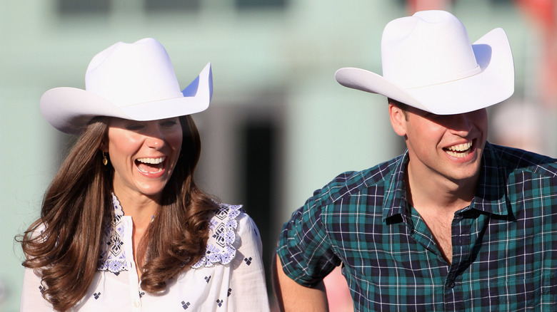 Kate Middleton and Prince William laughing in cowboy hats