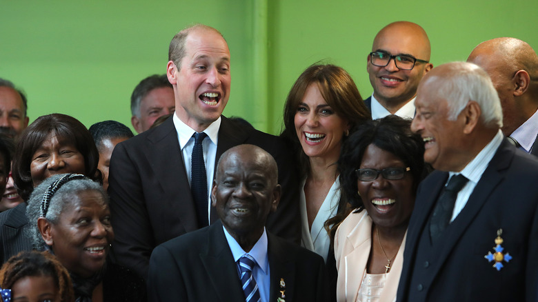 Kate Middleton and Prince William smiling with others