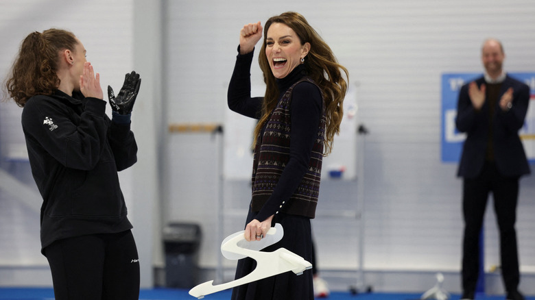 Kate Middleton celebrating as Prince William claps in the background