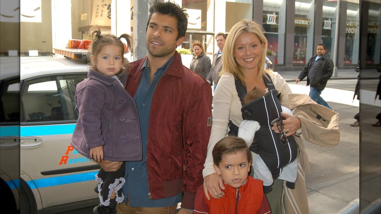 Mark Consuelos, Kelly Ripa, and their three kids smile together