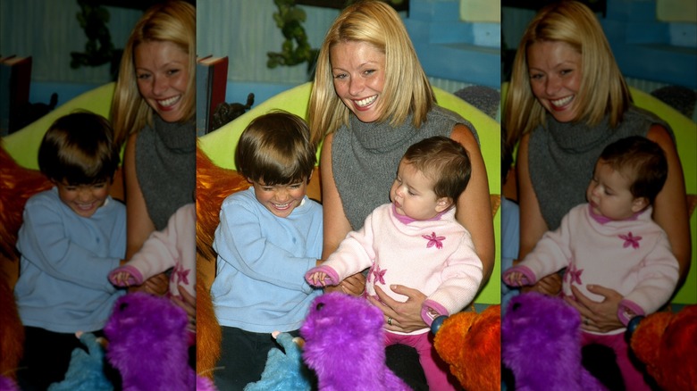 Kelly Ripa holds her kids Michael and Lola at "Bear in the Big Blue House."