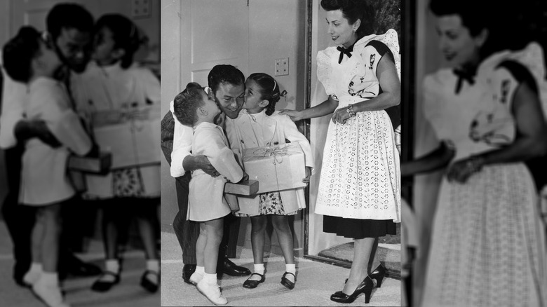 Frank Sinatra gets kisses on the cheeks from Frank Jr. and Nancy Jr. as wife Nancy looks on.