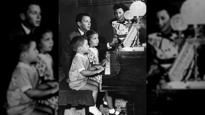The Sinatra family - Frank Jr., Nancy Jr., Frank, and Nancy - come together around the home piano.