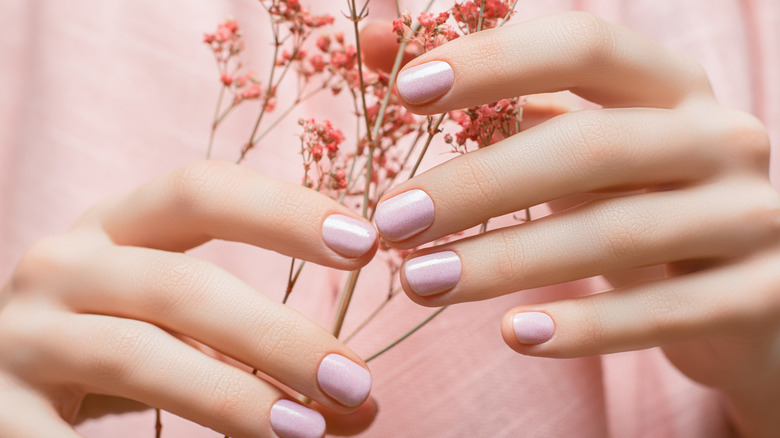 A woman with healthy looking nails and hands