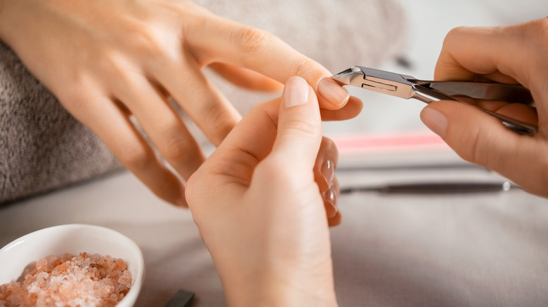 Cuticles being removed with clippers 