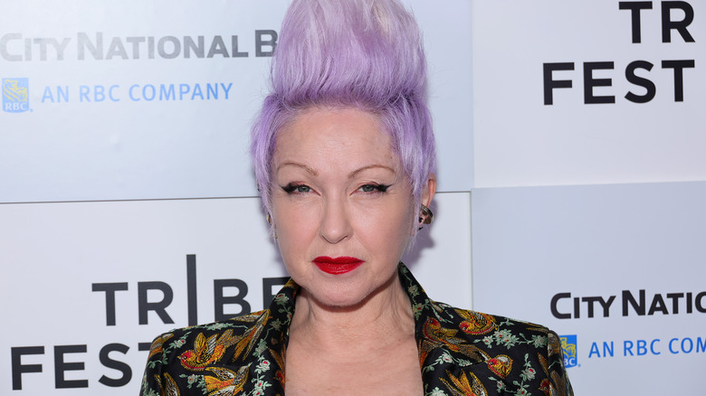 Cyndi Lauper posing with purple mohawk