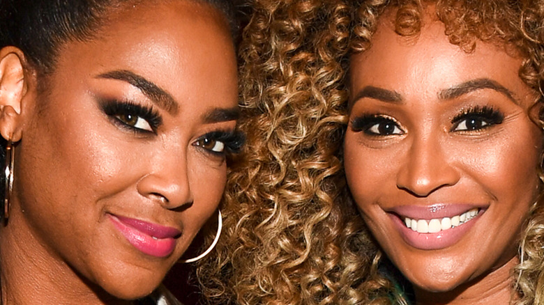 Cynthia Bailey and Kenya Moore smiling together at Growing Up Hip Hop Atlanta Premiere