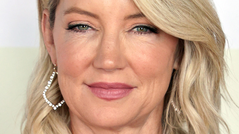 Cynthia Watros with slight smile and hoop earrings