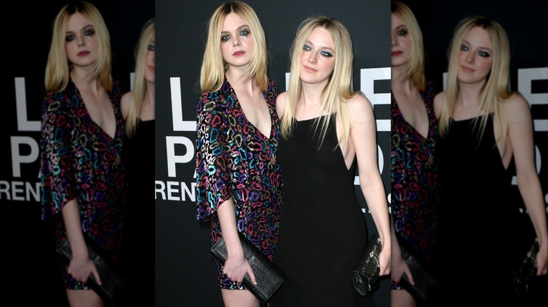 Actresses Elle Fanning (L) and Dakota Fanning attend Saint Laurent at Hollywood Palladium on February 10, 2016 in Los Angeles, California.