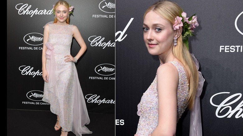 Dakota Fanning on the red carpet in a multi-layered dress with lots of detailing and flowers in her hair