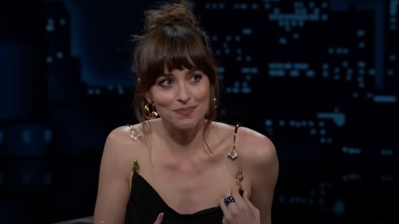 Dakota Johnson holding up her broken dress on "Jimmy Kimmel Live"