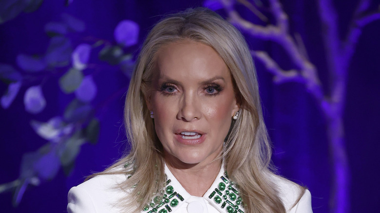 Dana Perino wearing white top with green gems on the collar