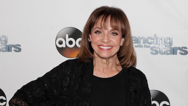 Valerie Harper posing in front of the Dancing With the Stars logo