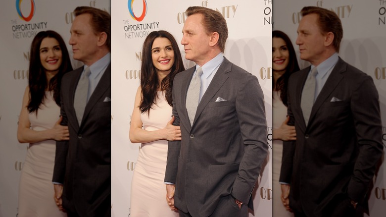 Rachel Weisz looks at Daniel Craig on red carpet