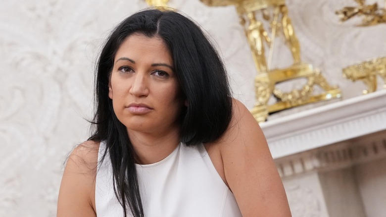 Katie MIller listens as Donald Trump and Elon Musk speak to reporters in the Oval Office in 2025