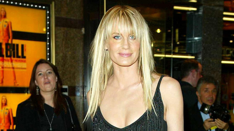 Daryl Hannah  wears a black dress at the premiere of "Kill Bill" with her hair down straightened