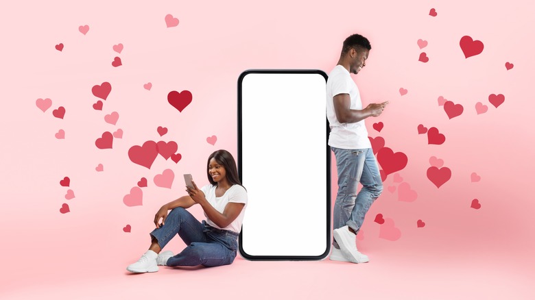 A man and woman pictured against a pink background texting each other 