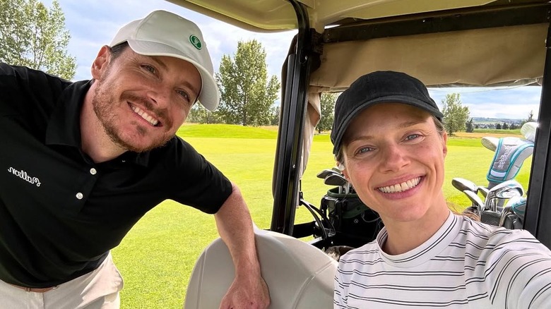 Tracy Spiridakos seated in a golf cart and Jesse Lee Soffer leaning down for a selfie.