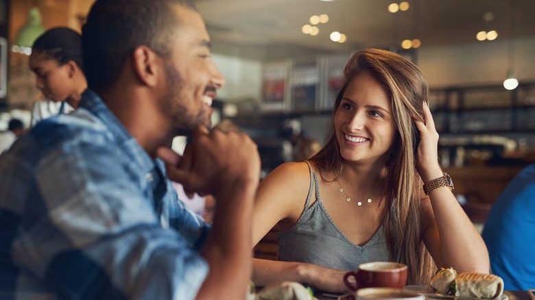 woman smiles at man on a date