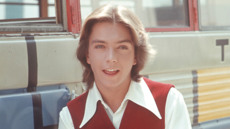 David Cassidy posing in front of the bus from 'The Partridge Family'